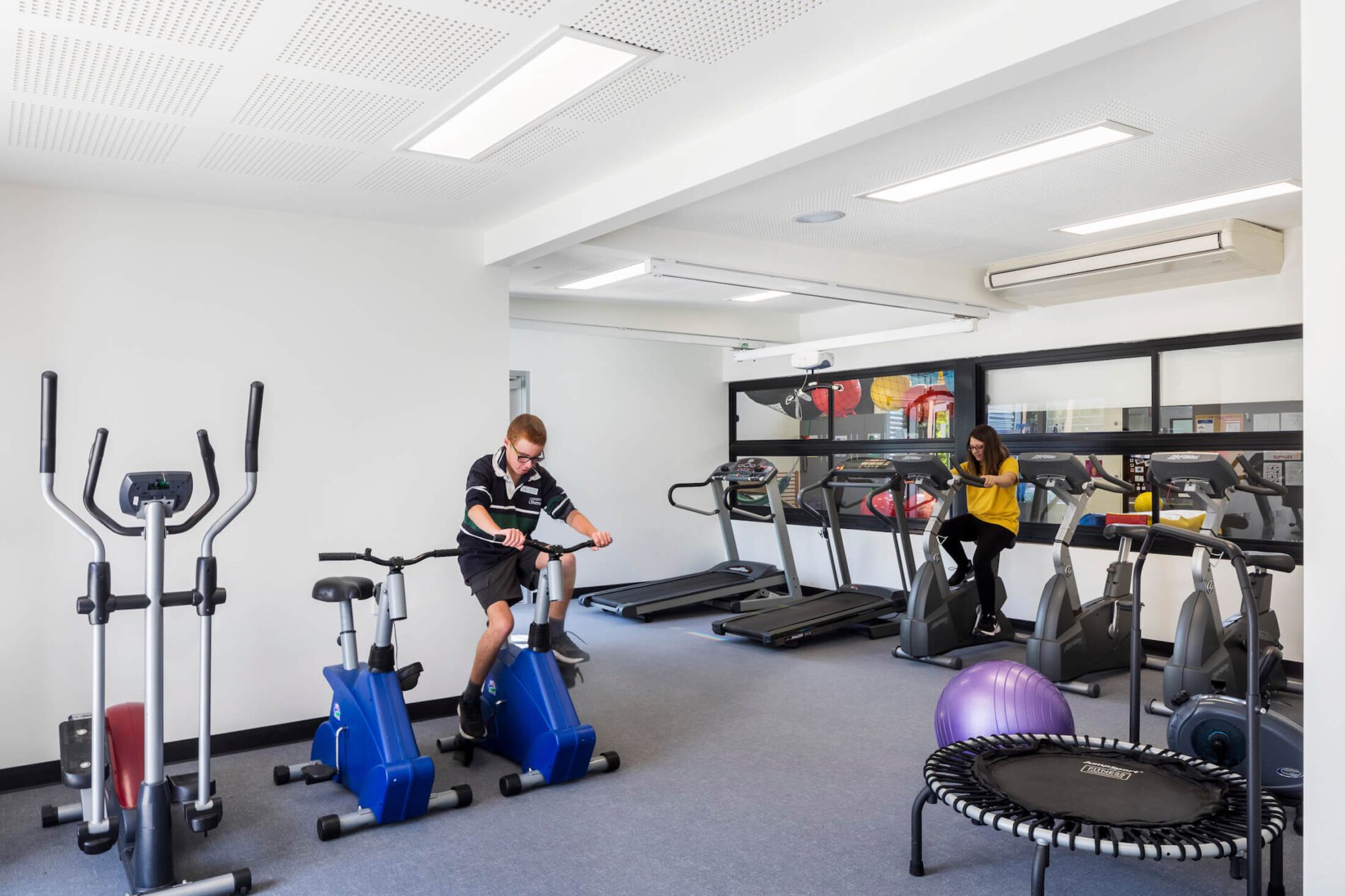 Students use exercise bikes in physical therapy room