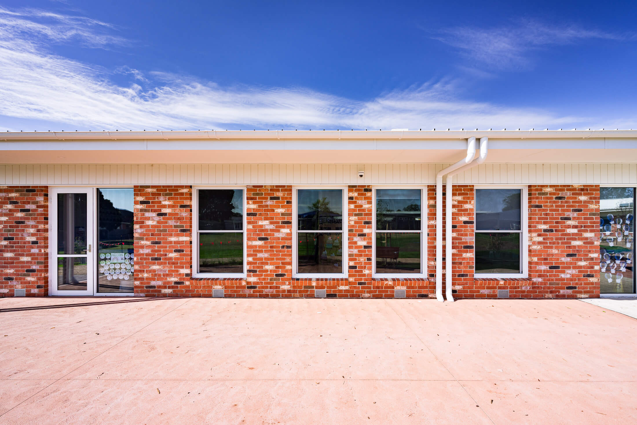 Modular brick school building, blue sky above