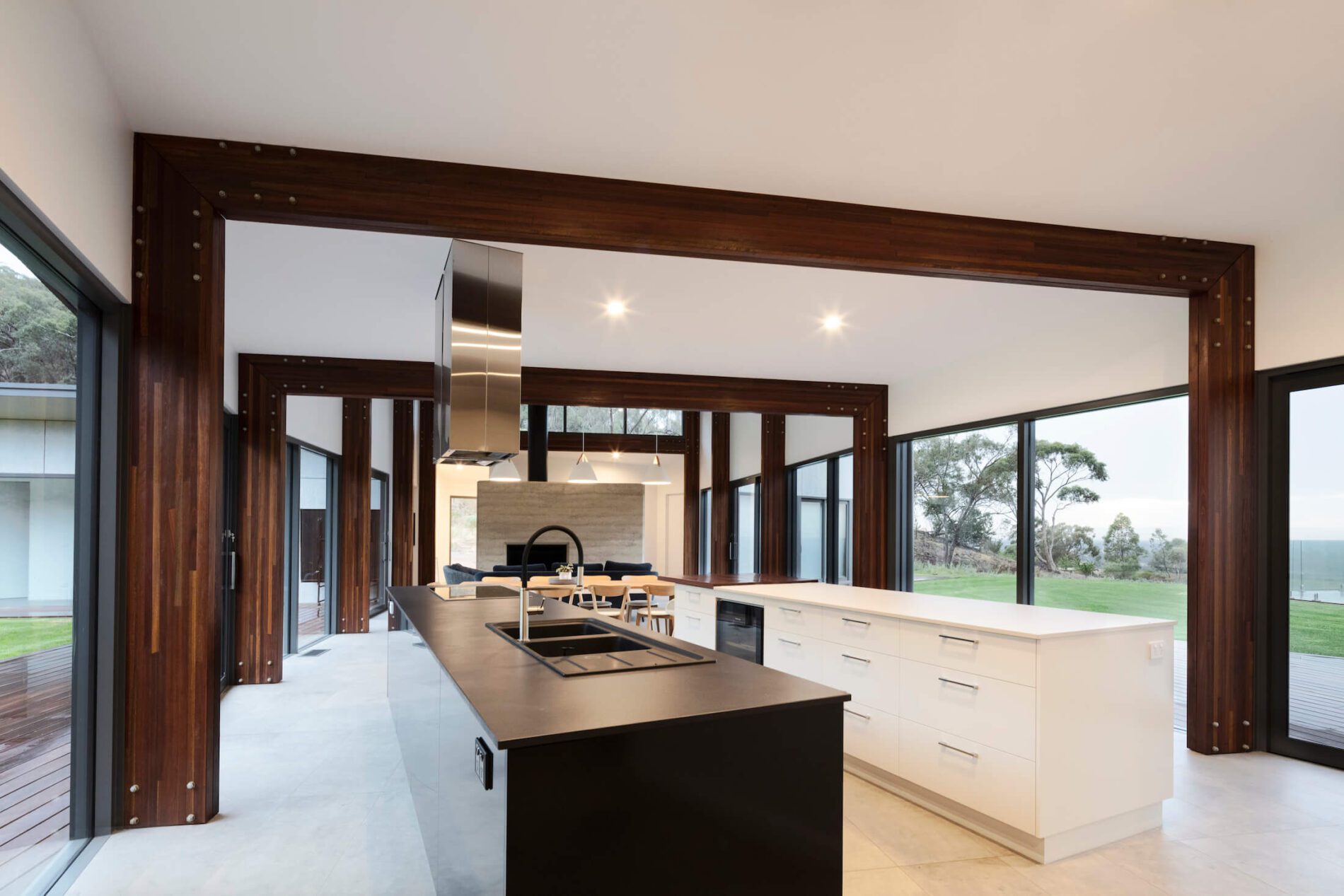 Contemporary kitchen with expressed timber beams and windows on all sides