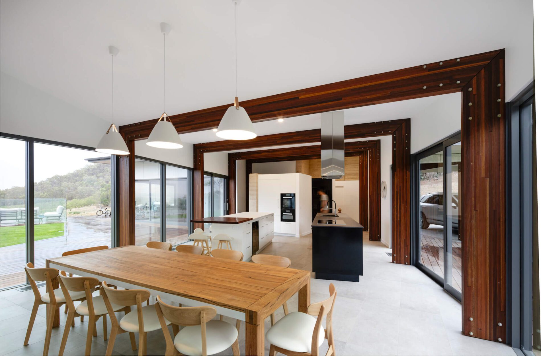 Contemporary kitchen, dining with views of bush and patio