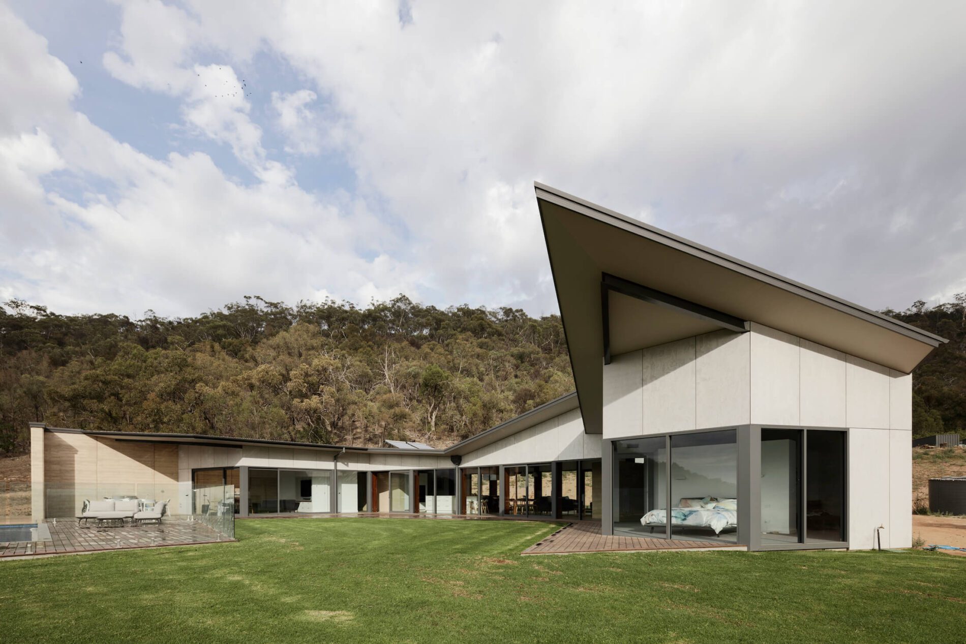 Contemporary residential home in the bush with angled canopy over main bedroom, bush beyond