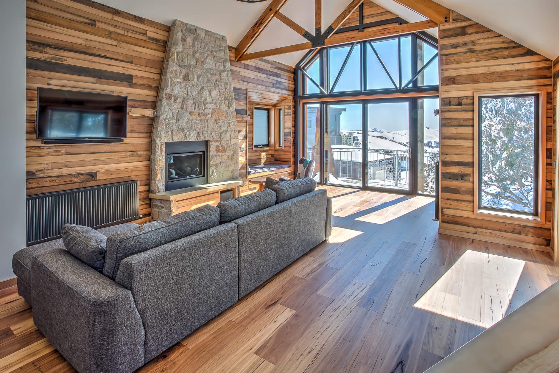 Chalet living room with gas log fire and views of the slopes