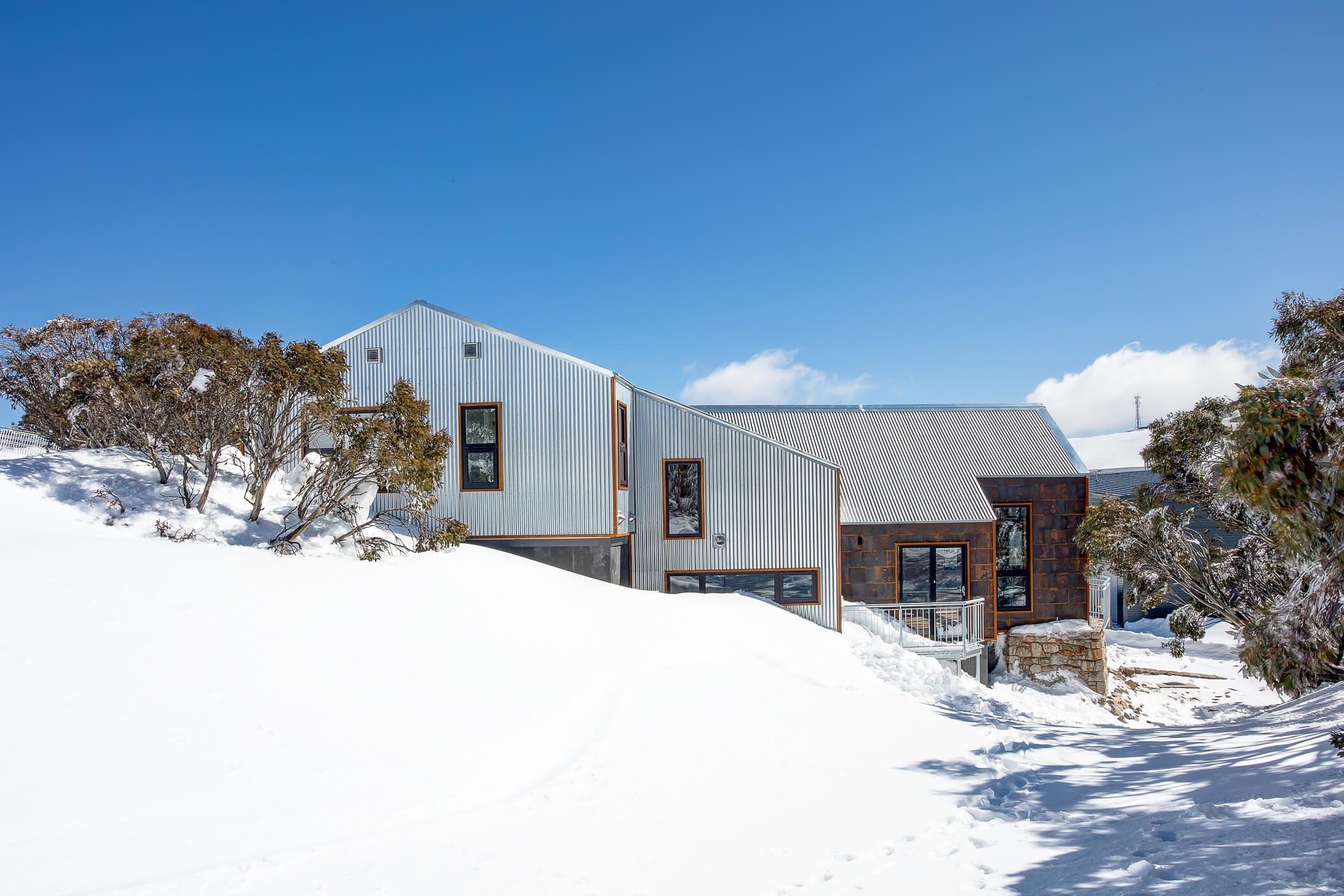 Metal clad snow chalet with deep snow all around