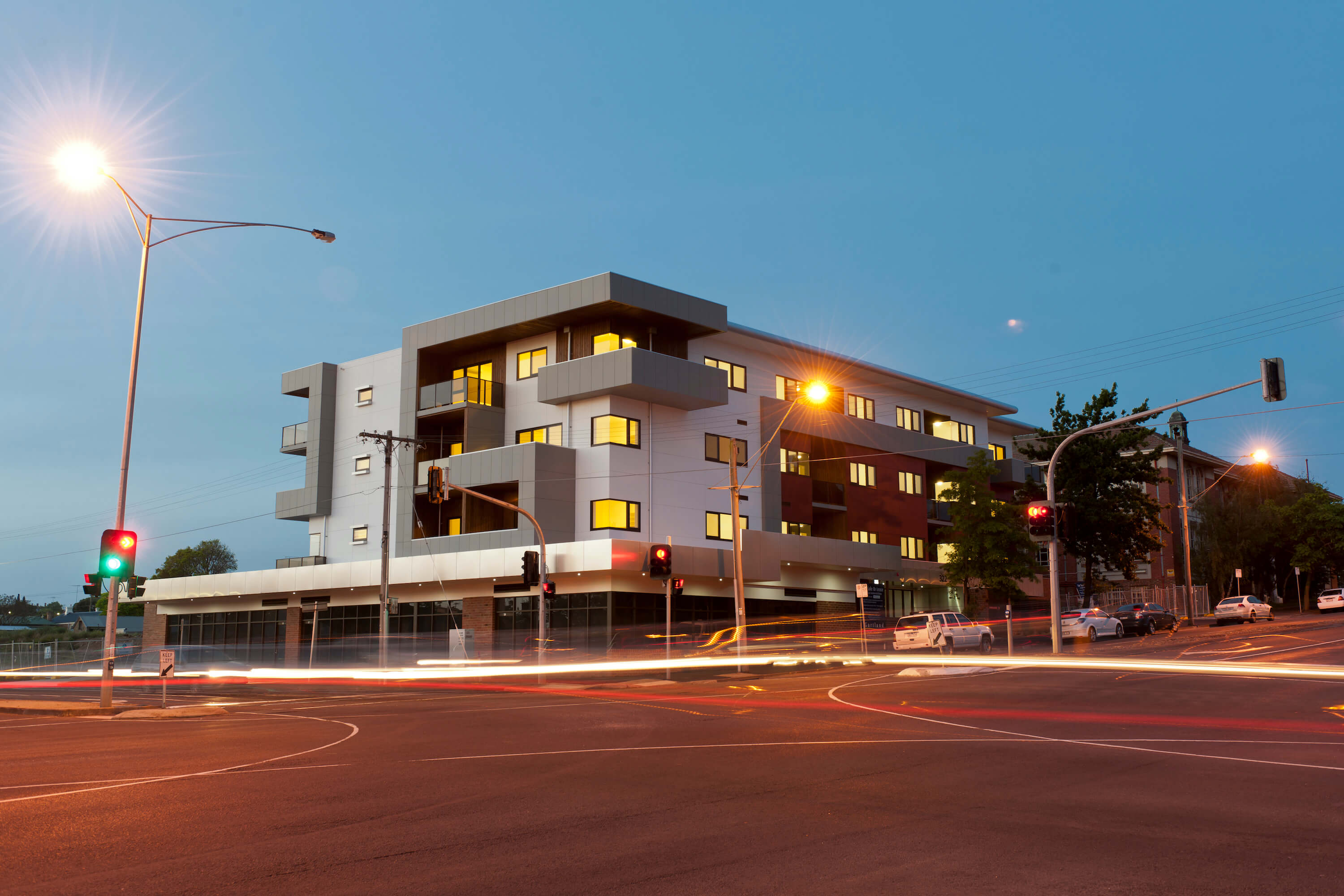 Night view of mixed use apartment building, traffic lights and traffic in long exposure photo