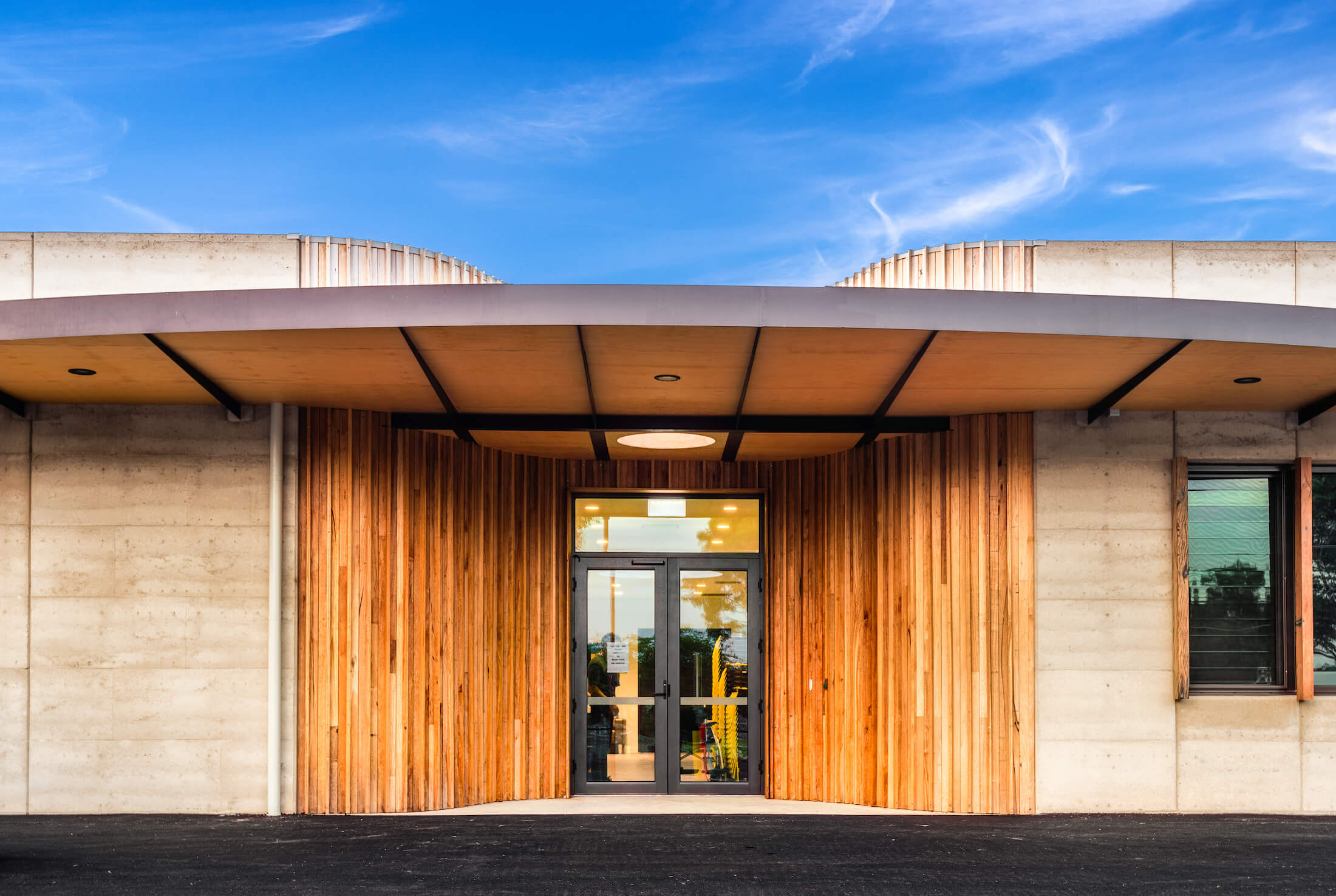 Timber feature cladding at community centre entry with canopy overhead