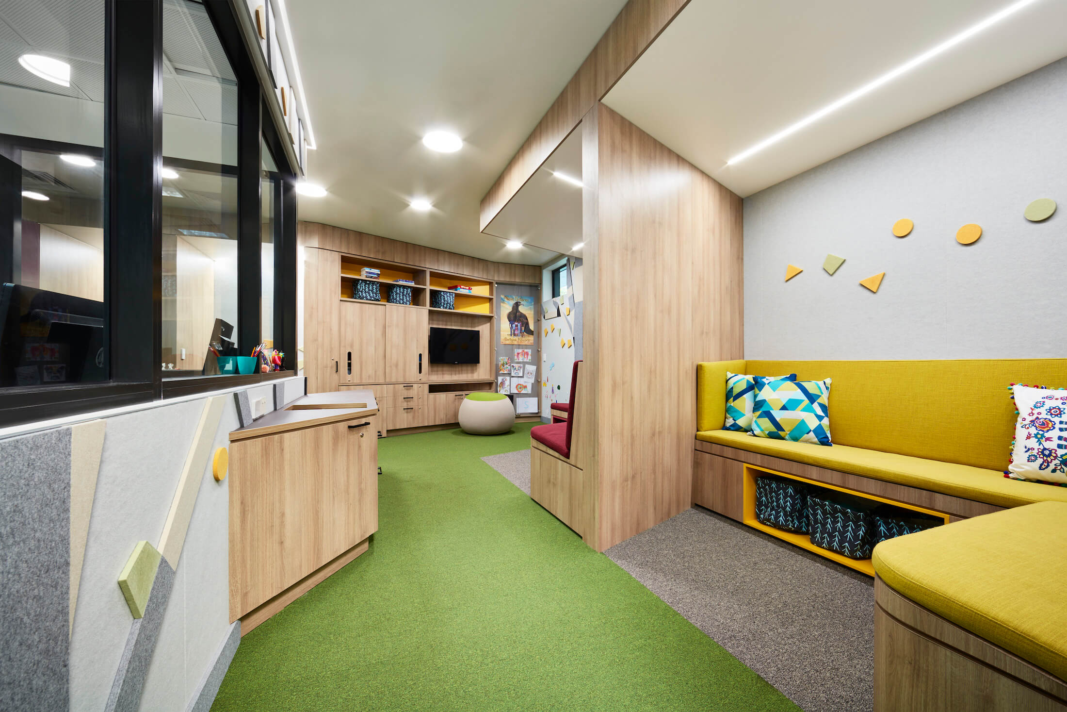 Children's cubby waiting area with staff office overlooking