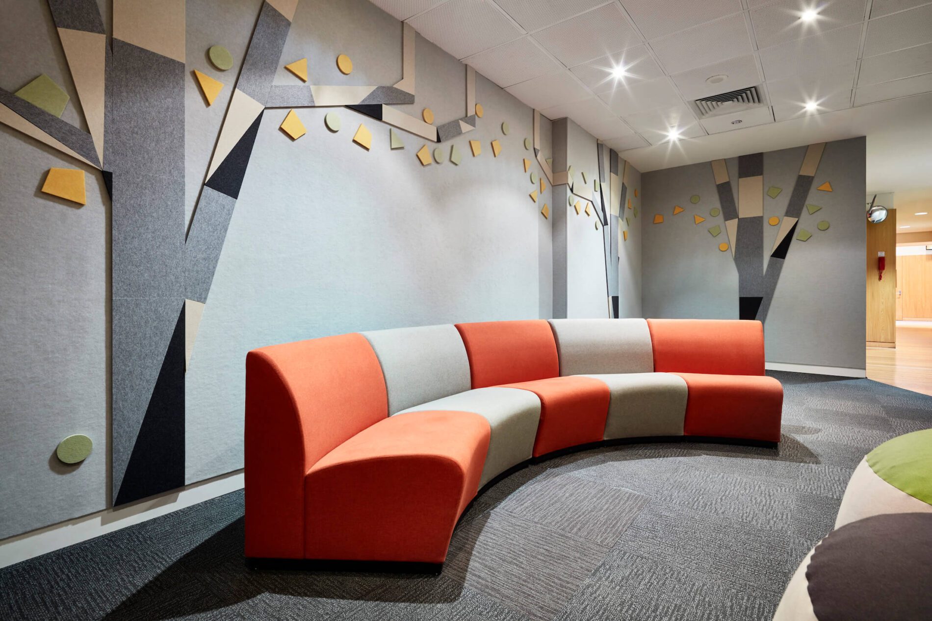 Curved, coloured seating, felt wall details in waiting areas