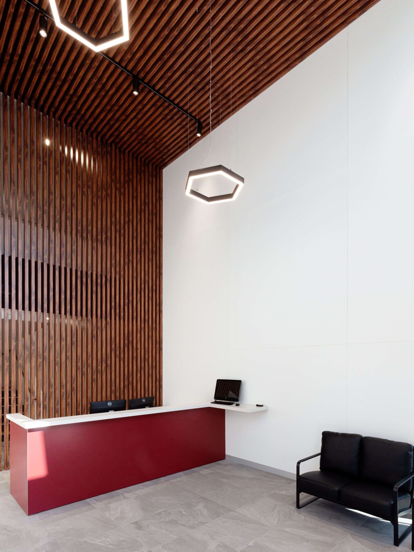 Timber lined reception with hexagonal lights overhead