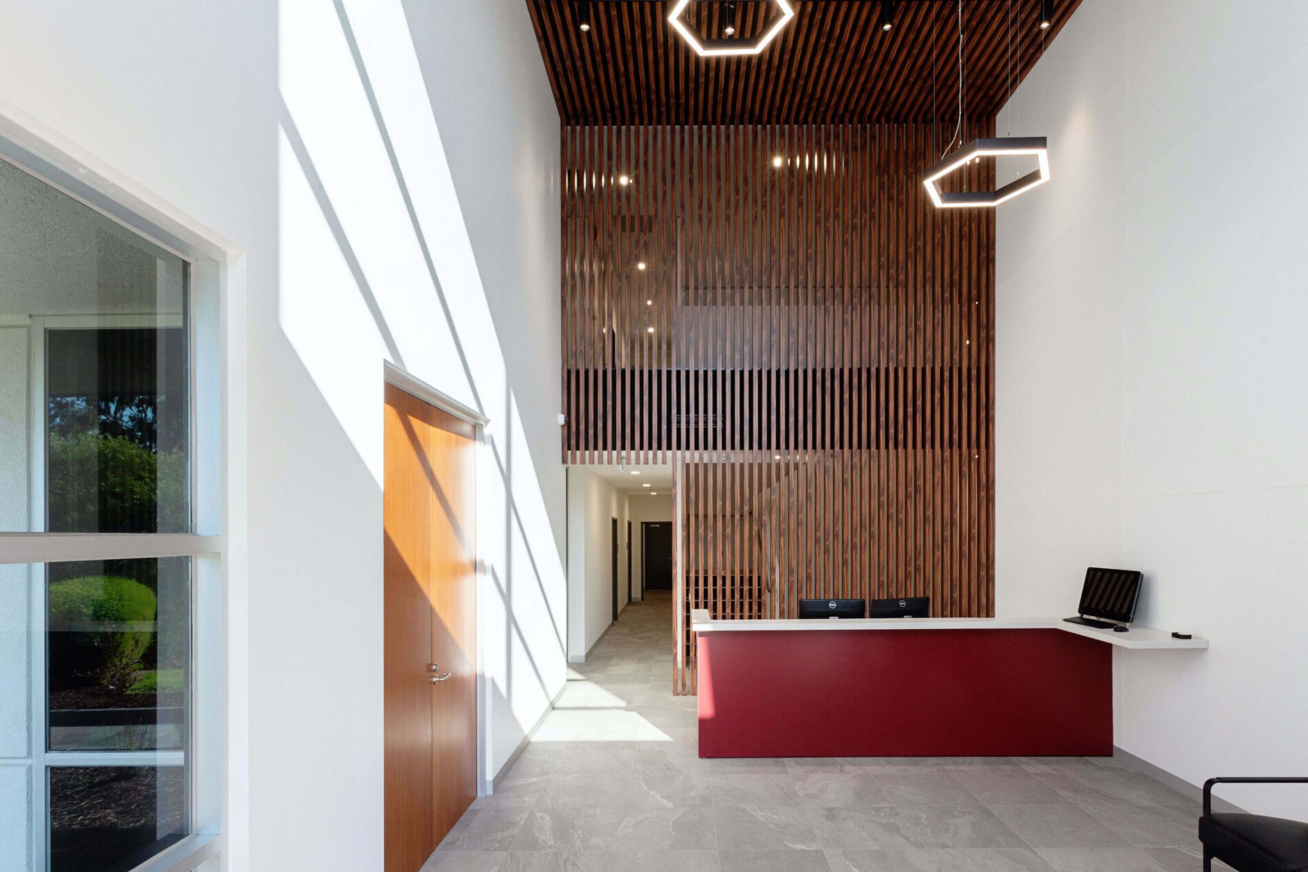 Timber lined reception with hexagonal lights overhead