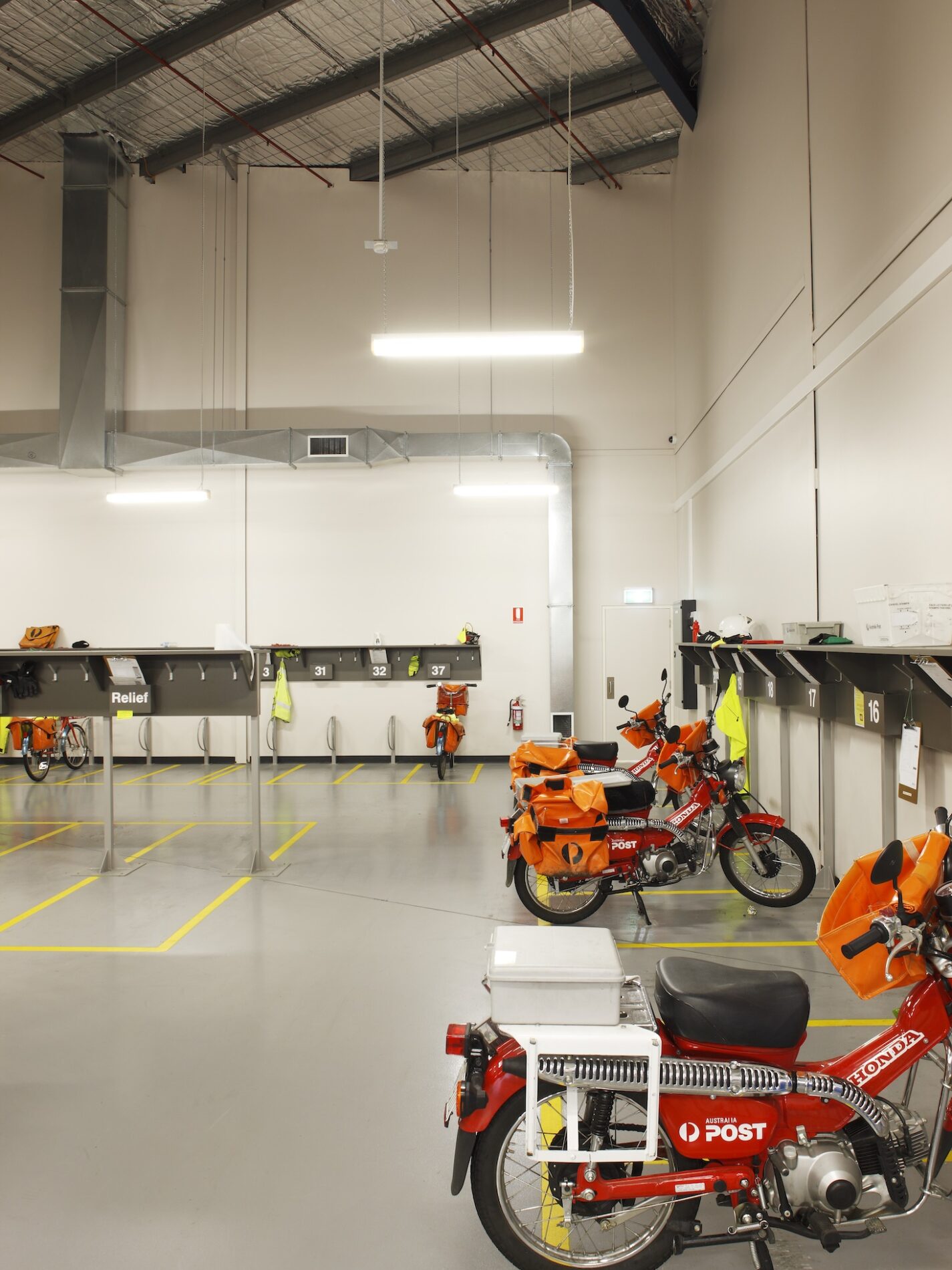 Australia Post postie biked in warehouse parking bays