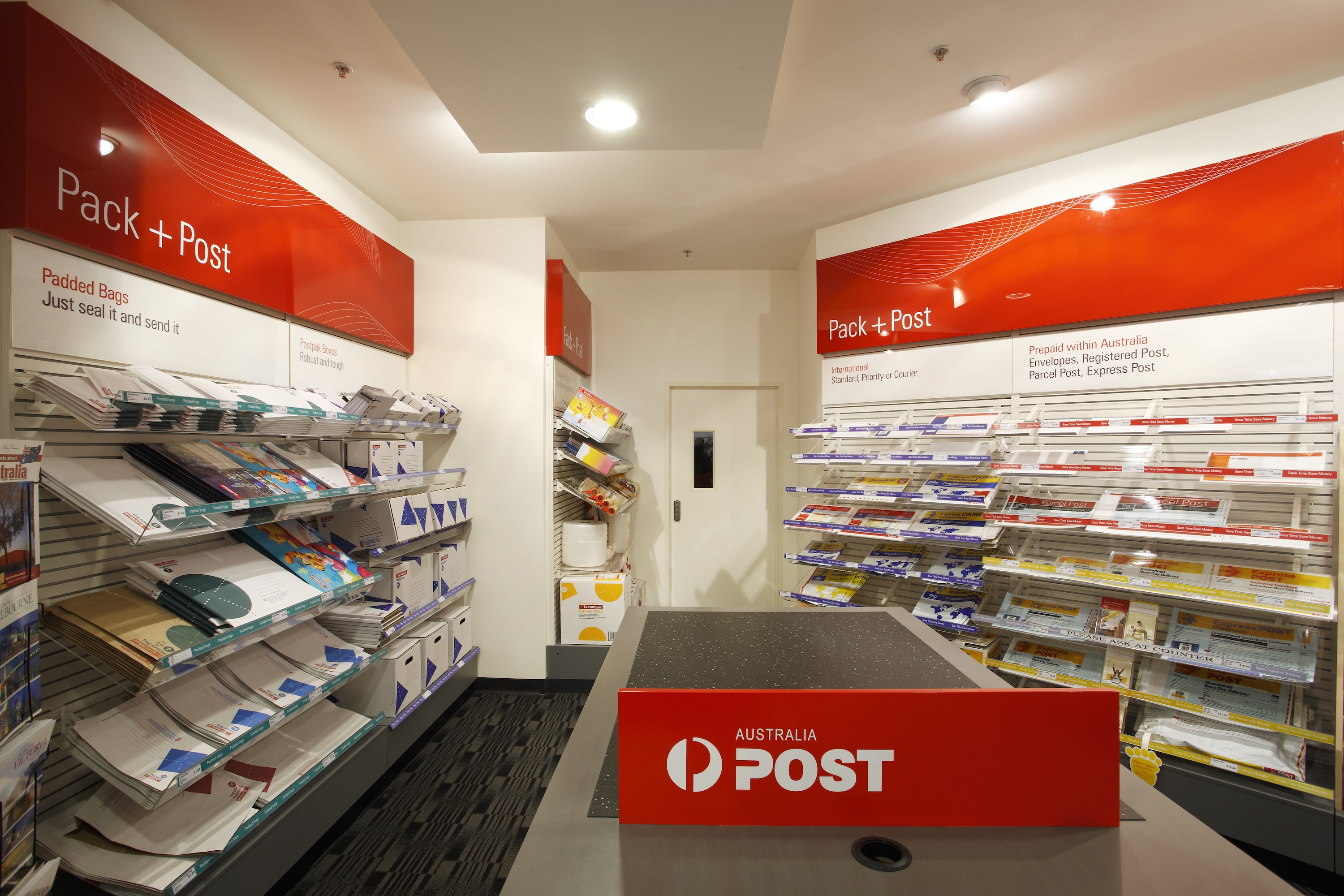 Interior of Australia Post shop with pack and post shelving