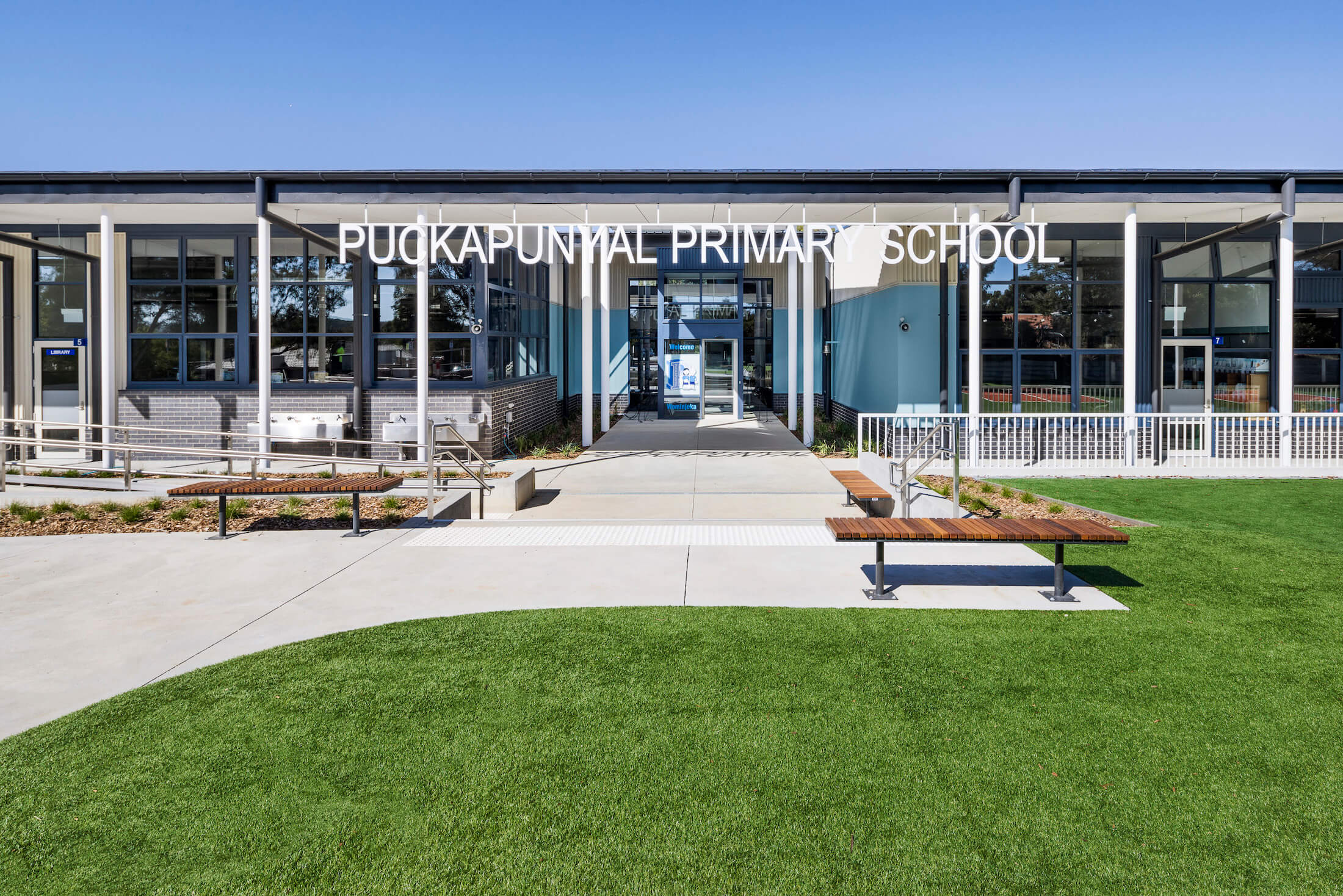 Forecourt to Puckapunyal Primary School with turf, paving and seating, white letter signage