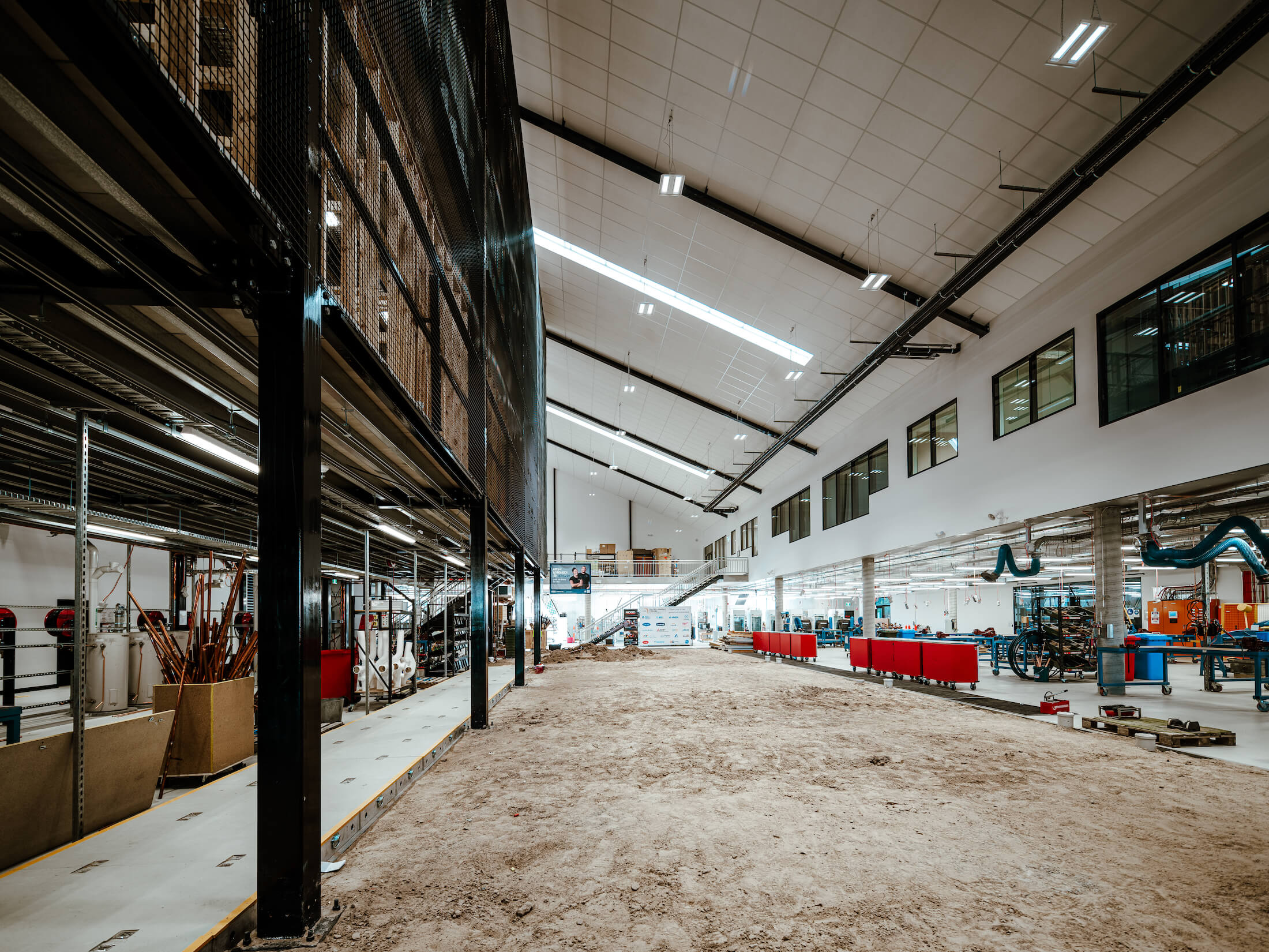 Long internal view of sandpit and multi-level stack inside of a trade training facility.
